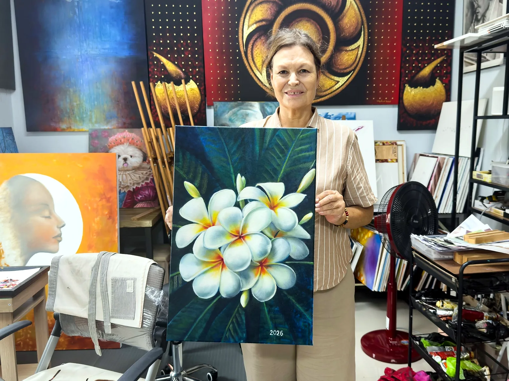 Adult student presenting a plumeria painting
