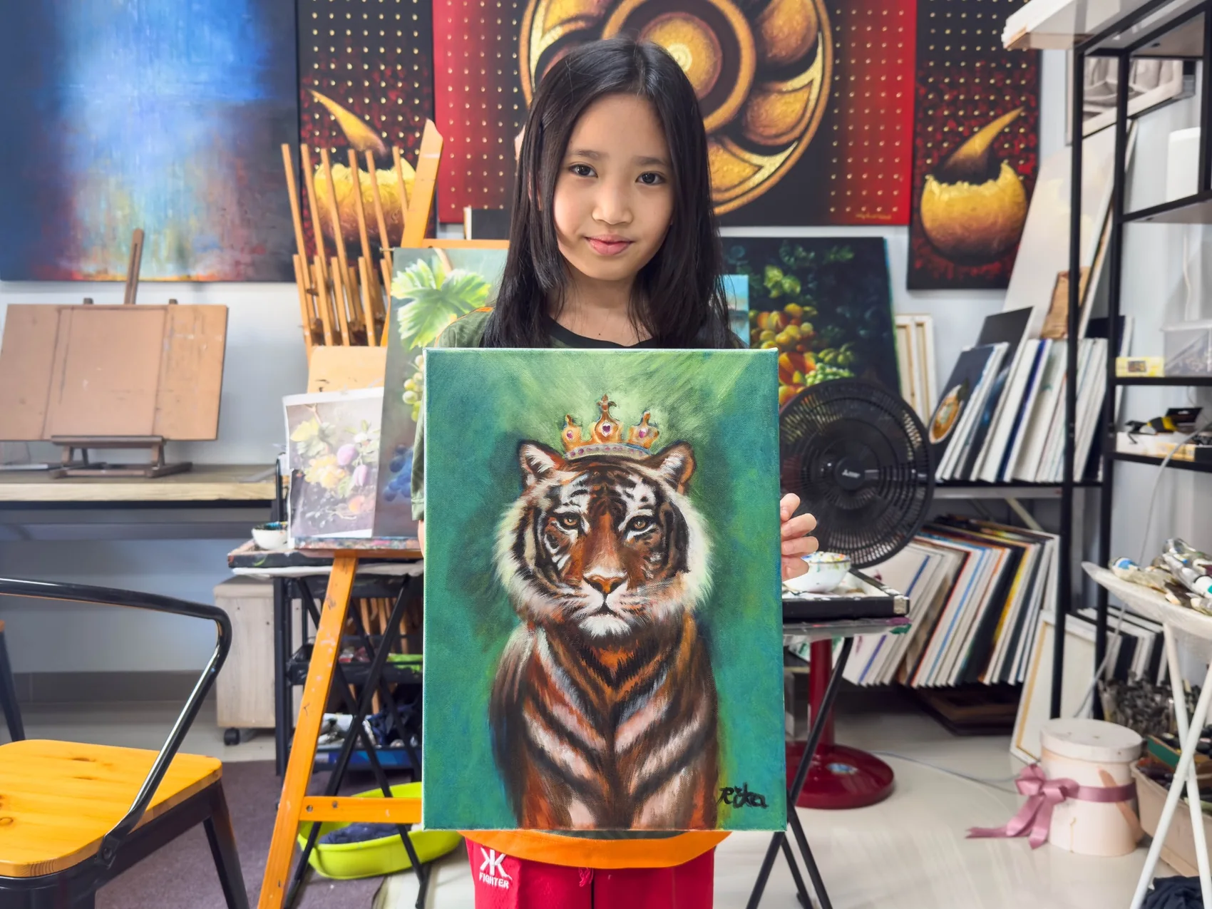 Young student presenting a finished painting