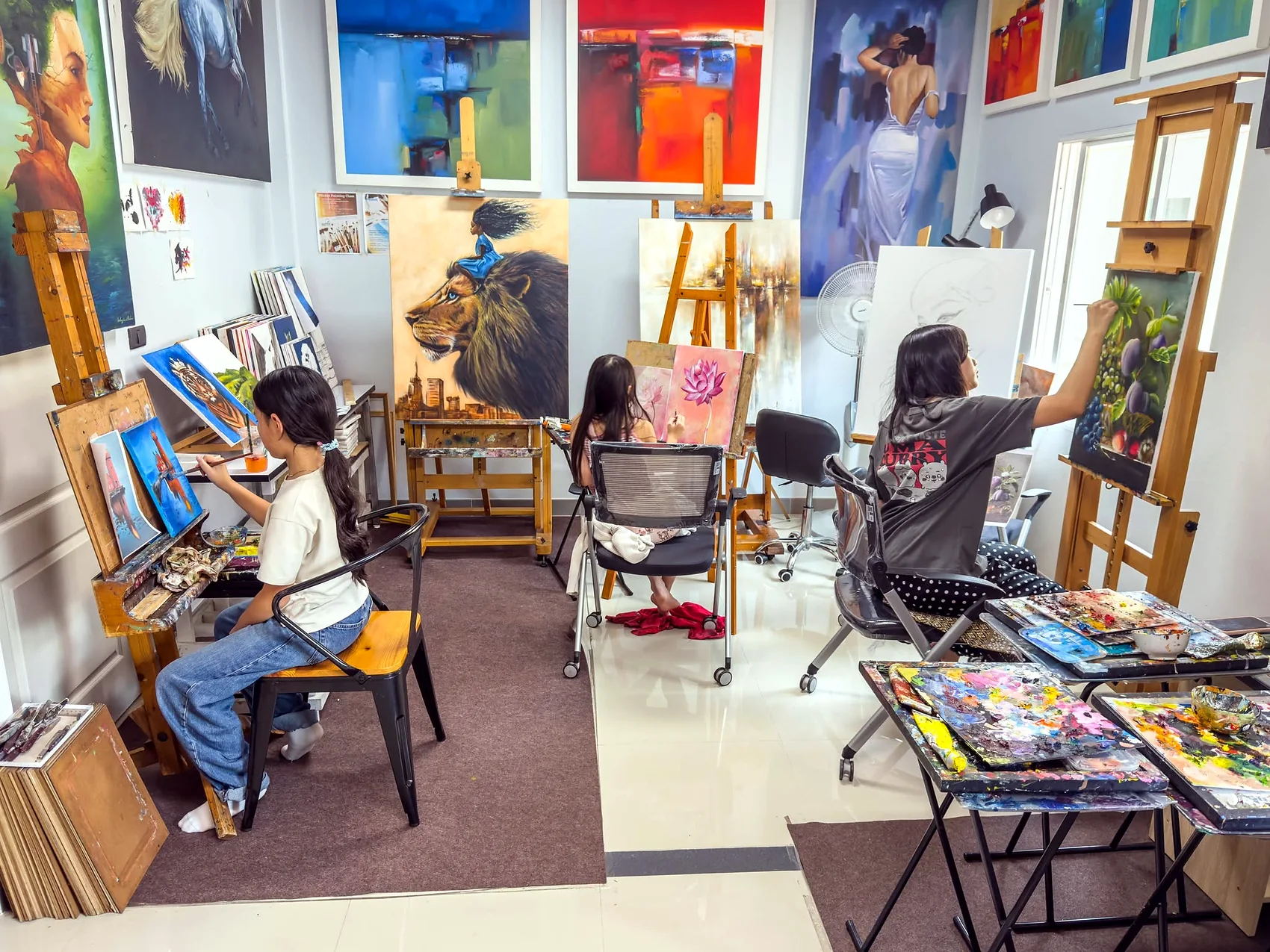 Young artists painting independently in the studio
