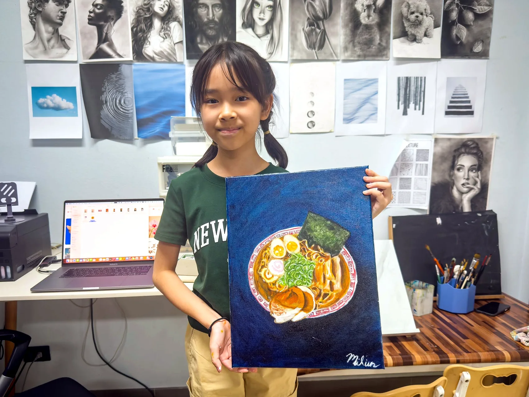 Young student presenting a ramen painting